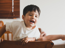 A toddler climbing out of a crib