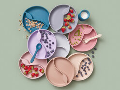 Colorful plastic plates with snacks