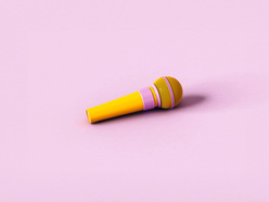 A yellow microphone on a pale pink background